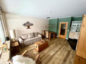 a living room with a couch and a table at Mountain Lodge in Sankt Andreasberg +16 photos