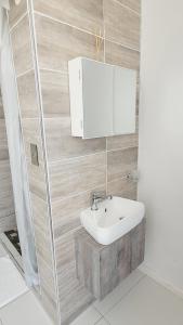a bathroom with a sink and a mirror at Effortless Self Catering Accommodation in East London