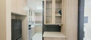 a kitchen with wooden cabinets and a sink at Effortless Self Catering Accommodation in East London