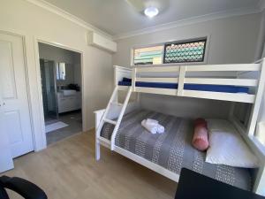 ein kleines Schlafzimmer mit einem Etagenbett und ein Badezimmer in der Unterkunft Redcliffe in Redcliffe