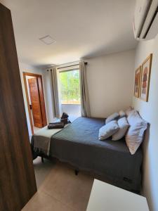 a bedroom with a bed with pillows and a window at Taipu Lodge Beach in Marau
