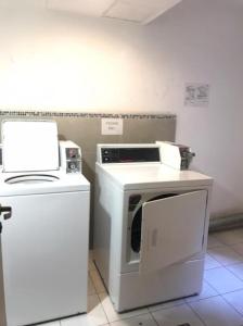 a kitchen with a washing machine and a microwave at El Rincon de Mia in Córdoba