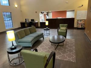 a lobby with a couch and chairs and a table at Americas Best Value Inn Pharr/McAllen in Pharr