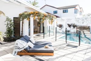 a house with a swimming pool next to a house at The River House includes a private beach jetty and pool in Noosa Heads