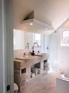 a bathroom with two sinks and a large mirror at Coral Point home in Governorʼs Harbour