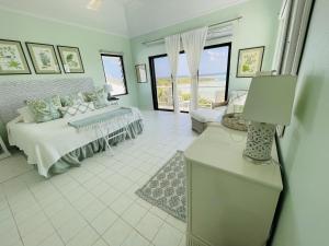 a living room with a bed and a couch at Halcyon House home in Savannah Sound