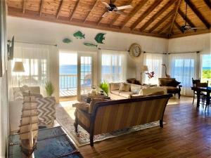 a living room with a couch and a table at Blue Love Point home in Gregory Town