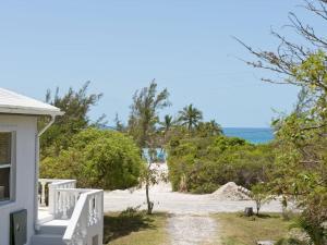 a view of the beach from the porch of a house at Key Lime Cottage home in Alice Town