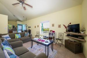 a living room with a couch and a table at Key Lime Cottage home in Alice Town