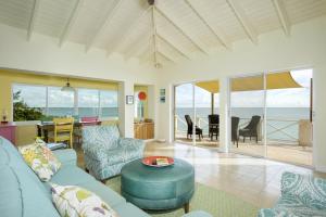 a living room with a couch and a table at Gurgle and Whump cottage in Hatchet Bay Limited Settlement