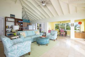 a living room with a blue couch and chairs at Gurgle and Whump cottage in Alice Town