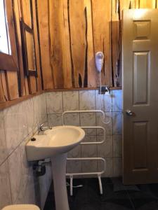 a bathroom with a sink and a hair dryer at Terrazas altos de Gamboa in Castro +57 photos