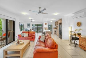 a living room with a couch and a table at Elysium Apartments in Palm Cove