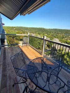 a deck with a table and chairs on a balcony at Treehouse Condos - Branson in Branson