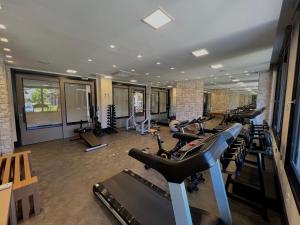 a gym with rows of treadmills and exercise bikes at Chateau Laghetto Collection in Gramado