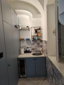a small kitchen with a sink in a room at Room Angel in Petrovaradin