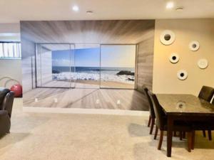 a dining room with a picture of the ocean at Luxury 3700 sq/ 5 bedroom/ jettedtub/ 4 fireplaces in Edmonton