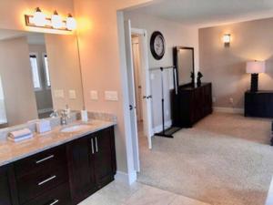 a bathroom with a sink and a mirror at Luxury 3700 sq/ 5 bedroom/ jettedtub/ 4 fireplaces in Edmonton +132 photos
