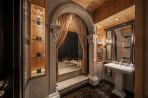 a bathroom with a tub and a sink at Meritel Hanoi in Hanoi