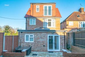 a brick house with a bench in front of it at Newly Refurbished Modern 4 Bed Detached House ! in Oxford