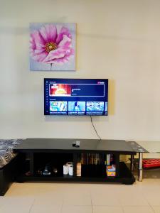 a flat screen tv sitting on top of a table at Le'Coco Homestay in Tiara Desaru Residence in Desaru