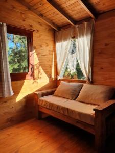 a bedroom with a bed in a room with windows at Albaricoque in Tigre