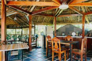 a kitchen with a wooden ceiling and a table and chairs at Palmera Palma Top Floor in Moalboal