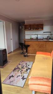sala de estar con sofá y cocina en Cabañas Isla Del rey, en Valdivia