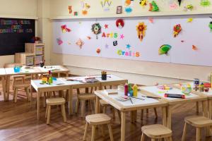 a classroom with tables and chairs and a chalkboard at PARKROYAL Penang Resort in Batu Ferringhi
