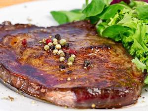 a piece of meat on a plate with a salad at The Italian countryside - Agriturismo Collina Delle Streghe 