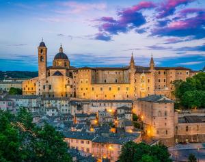 a large building with a city in front of it at The Italian countryside - Agriturismo Collina Delle Streghe 