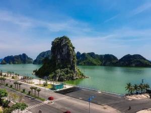 a view of a lake with a mountain in the water at TiGon Hotel in Ha Long