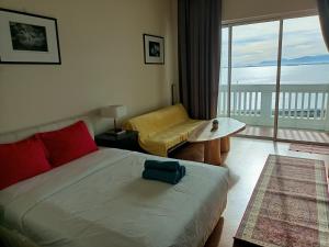 a bedroom with a bed and a view of the ocean at Penang Straits Quay Marina Suites By AuroraHomes in Bagan Jermal