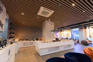 a restaurant with a counter with food on it at Aiden by Best Western Cheongdam in Seoul