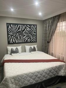 a bedroom with a large bed in front of a window at The Villa 442 in Pretoria