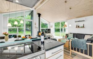a kitchen with a counter and some windows at Nice Home In Asaa With Kitchen in Aså