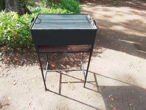 a grill sitting on a stand on a sidewalk at Villa Colibri in Nosy Be