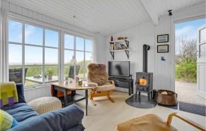 a living room with a couch and a fireplace at Gorgeous Home In Brenderup Fyn With Wifi in Vedelshave