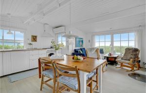 a kitchen and dining room with a table and chairs at Gorgeous Home In Brenderup Fyn With Wifi in Vedelshave