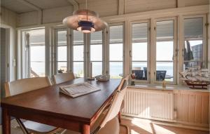 ハザスレウにあるLovely Home In Haderslev With House Sea Viewのダイニングルーム(テーブル、椅子、窓付)