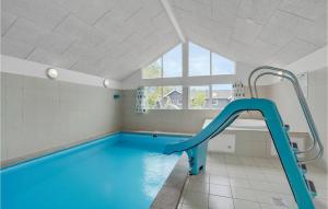 a swimming pool with a blue slide in a room at Cozy Home In Nordborg With Kitchen in Nordborg
