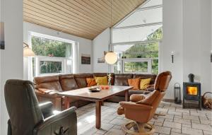 a living room with a couch and a table at Holiday Home Hadsund 02 in Hadsund