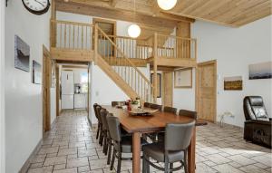 a dining room with a wooden table and chairs at Holiday Home Hadsund 02 in Hadsund