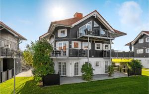 a black and white house with a balcony at Nice Apartment In Bogense With Wifi in Bogense