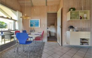 a kitchen and dining room with a table and chairs at Awesome Home In Fan With 3 Bedrooms, Sauna And Wifi in Fanø