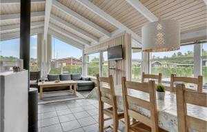 a kitchen and living room with a table and chairs at Birkely in Nyborg