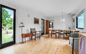 a living room with a table and a dining room at Lovely Home In Sjllands Odde With Wifi in Tjørneholm