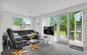 a living room with a couch and a television at Pet Friendly Home In Vinderup With Sauna in Vinderup