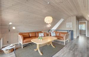 a living room with a couch and a table at Holiday Home Thadesvej Rømø X in Toftum