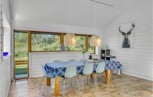 a dining room with a blue table and chairs at Three-Bedroom Holiday Home In Farevejle in Fårevejle